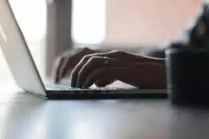 Person typing on a laptop.